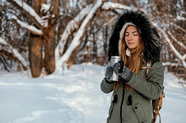 Portrait woman with backpack on winter day