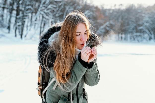 Portrait woman with backpack on winter day