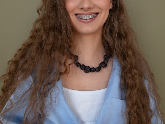 Free Photo portrait of woman with blueberry necklace