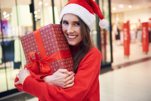 Portrait of woman with Christmas present at the store