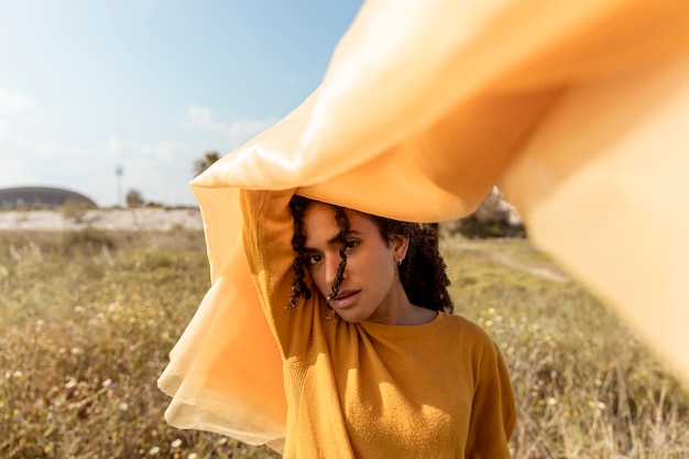 Free photo portrait of woman with cloth in the fields