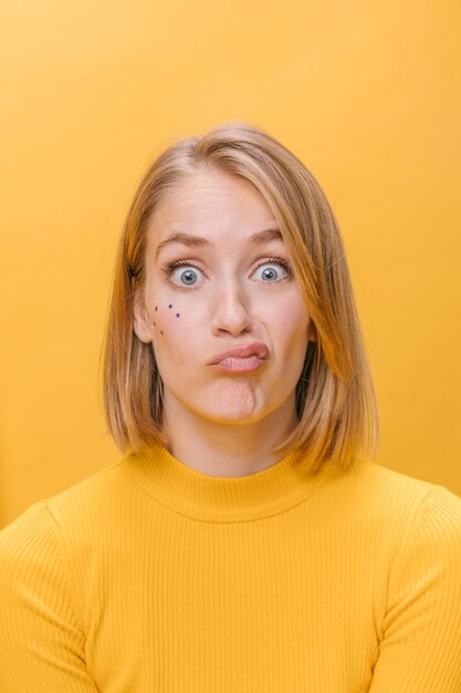 Portrait of woman with different facial expressions in a yellow scene