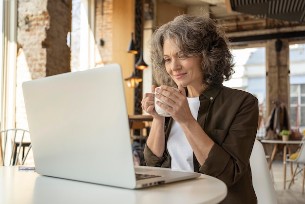 Free Photo portrait woman with laptop working