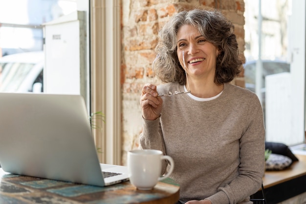 Portrait woman with laptop working