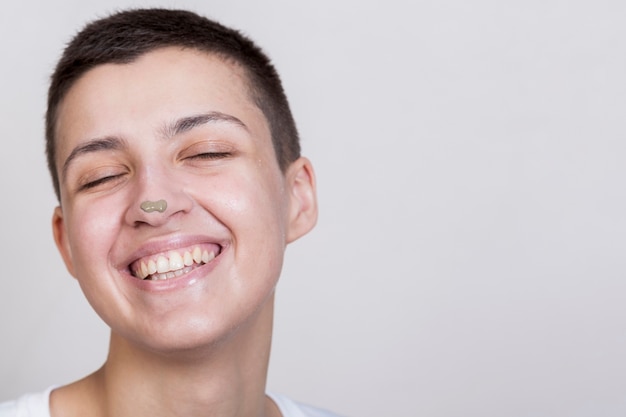 Portrait woman with mud treatment on nose