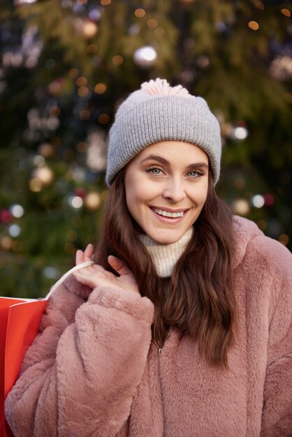 Portrait of woman with shopping bag on Christmas market