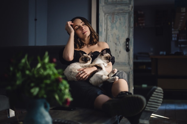 Free Photo portrait woman with siamese cats