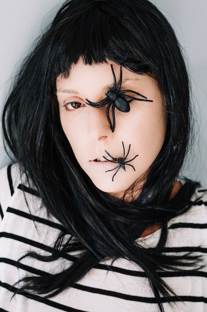 Free photo portrait of woman with spiders on face