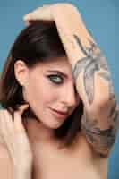 Free photo portrait of woman with tattoo