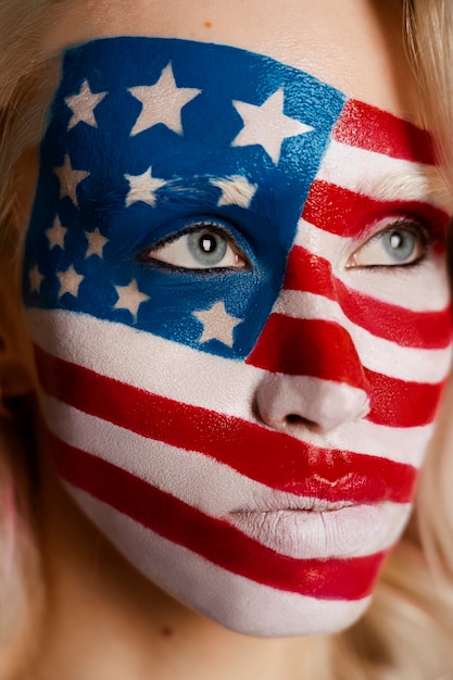 Free photo portrait of woman with usa flag make-up on her face