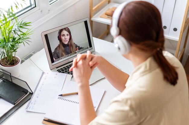 Portrait woman at work having video call on laptop