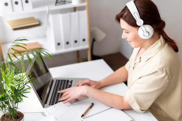 Portrait woman at work having video call on laptop