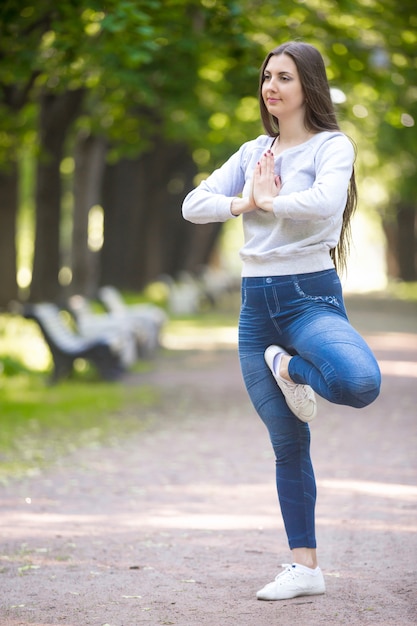 Portrait of yogi woman standing in Vrikshasana pose