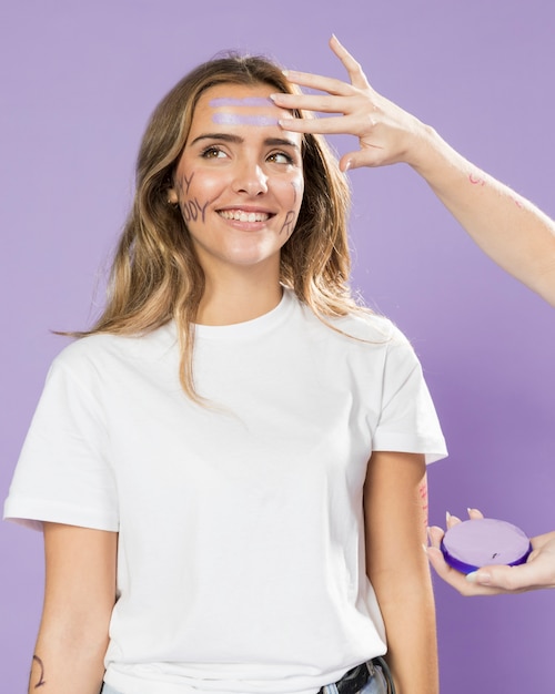 Portrait of young activist painting her face