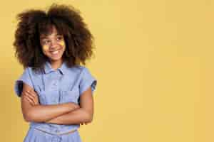 Free photo portrait of young adorable girl posing with emoji stickers on her face