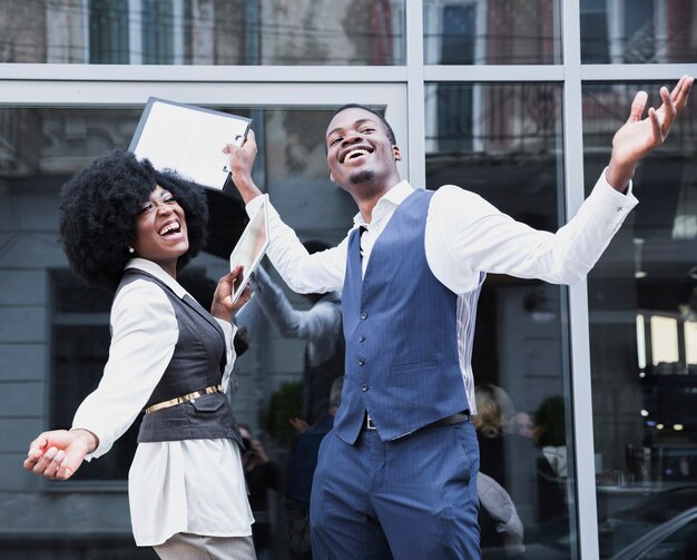 Portrait of a young african businessman and businesswoman enjoying the success