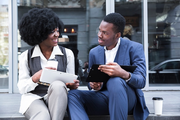 Portrait of a young african businessman and businesswoman taking a office break