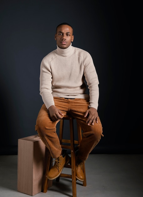 Portrait young african man sitting on chair