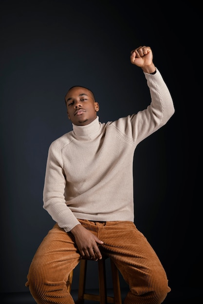 Portrait young african man with hand rised