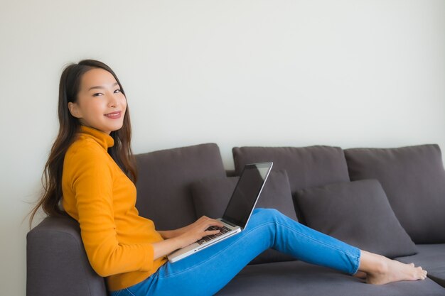 Portrait young asian woman using laptop computer note book on sofa