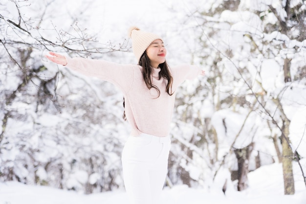 Portrait Young Beautiful asian woman smile happy travel and enjoy with snow winter season