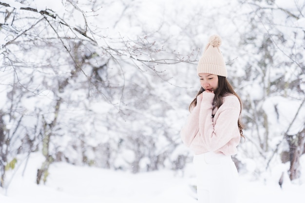 Portrait Young Beautiful asian woman smile happy travel and enjoy with snow winter season