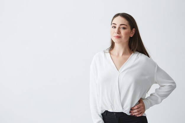 Portrait of young beautiful brunette businesswoman smiling posing .