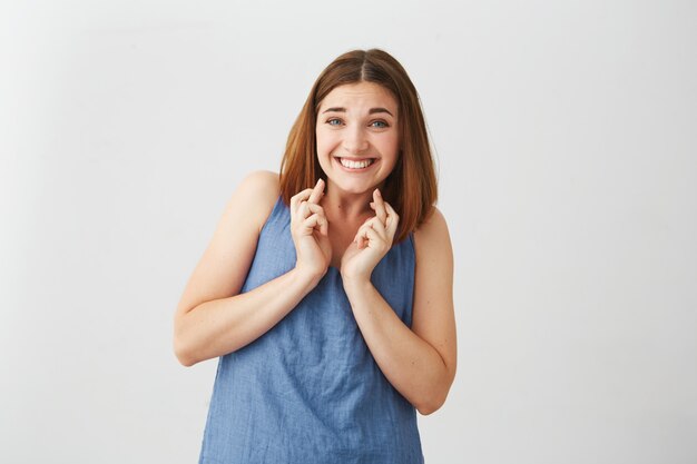 Portrait of young beautiful brunette girl praying .