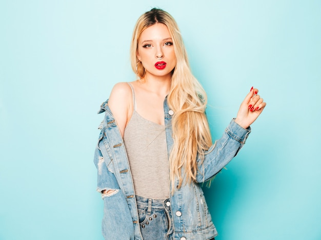 Free Photo portrait of young beautiful hipster bad girl in trendy jeans  clothes and earring in her nose.  positive model having fun