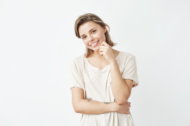 Portrait of young beautiful shy girl smiling .