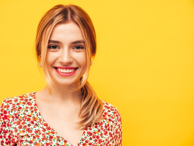 Free photo portrait of young beautiful smiling blond female in trendy summer clothes carefree woman posing near yellow wall in studio positive model having fun indoors cheerful and happy