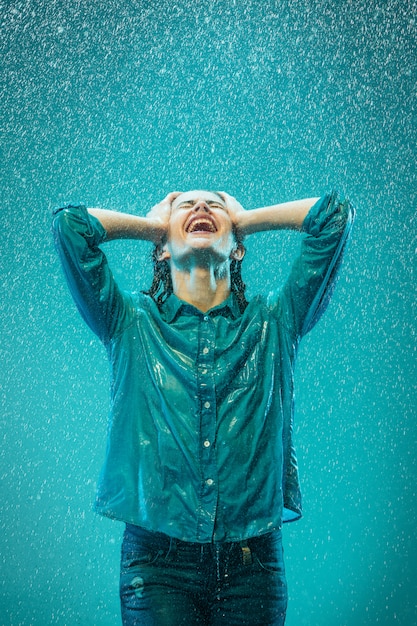 Free Photo the portrait of young beautiful woman in the rain