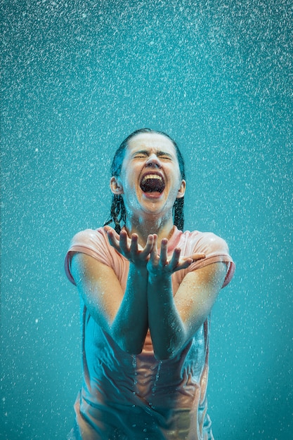 Free Photo portrait of young beautiful woman in the rain