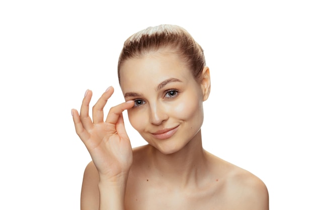 Free Photo portrait of young beautiful woman with perfect no makeup face isolated over white studio background