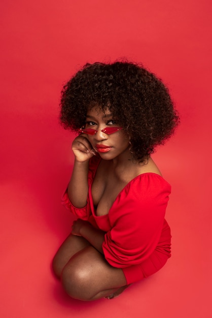 Portrait of young beautiful woman with red dress