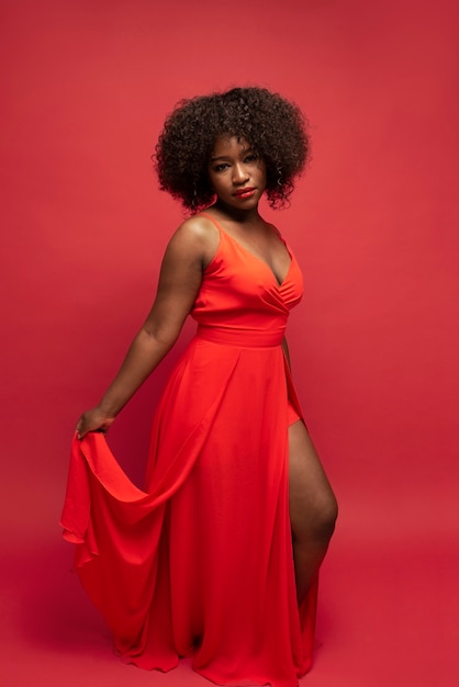 Portrait of young beautiful woman with red dress