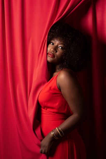 Portrait of young beautiful woman with red dress