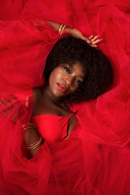 Portrait of young beautiful woman with red dress