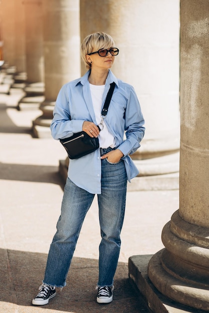 Free Photo portrait of young blonde woman posing in the street