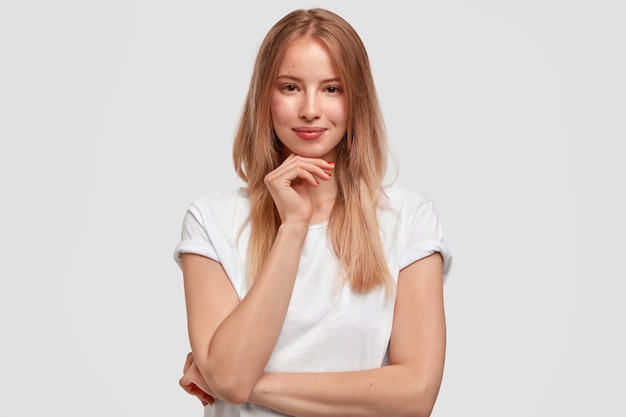 Portrait of young blonde woman in white T-shirt