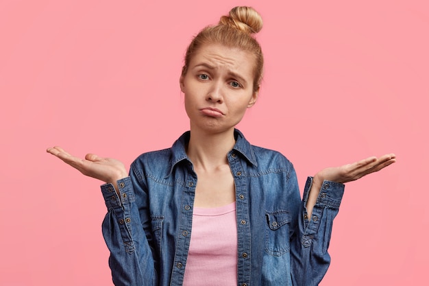 Free Photo portrait of young blonde woman with hair in a bun