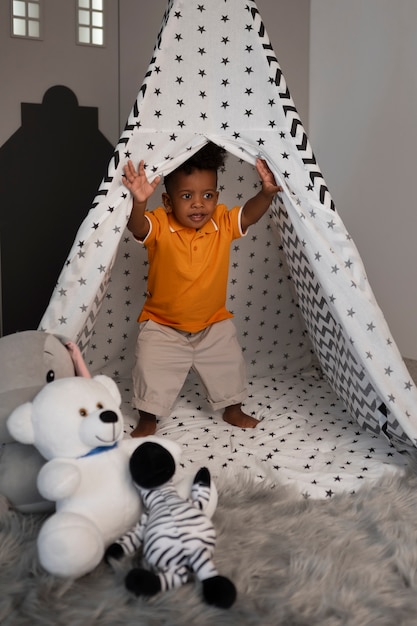 Free Photo portrait of young boy playing with his stuffed animal toy