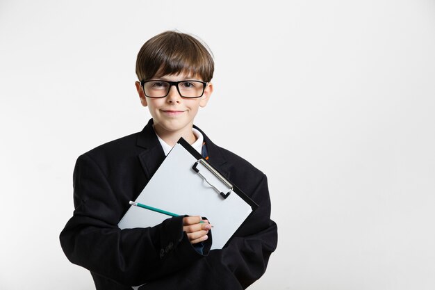 Portrait of a young boy posing as a businessman