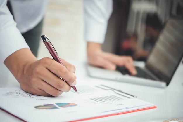 Portrait of young business man sitting at his desk in the office 