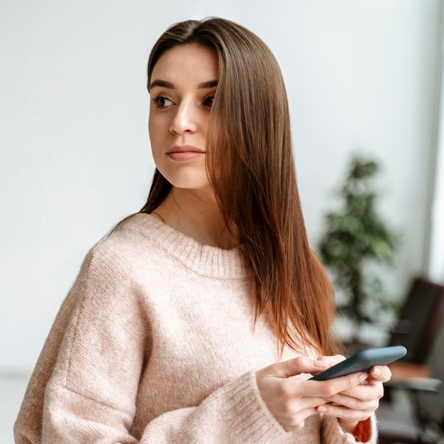 Portrait young business woman with mobile