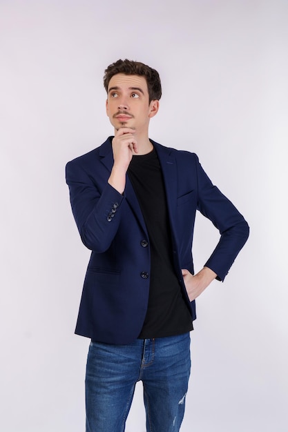 Free photo portrait of young businessman thinking touching chin isolated over white background