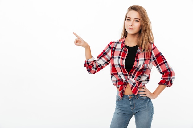 Free photo portrait of a young casual girl in plaid shirt standing