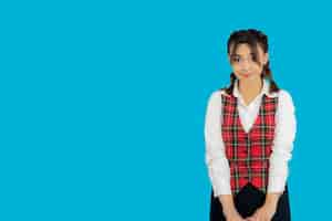 Free photo portrait of young college girl stand on blue background. high quality photo