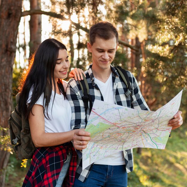 Portrait of young couple checking local map