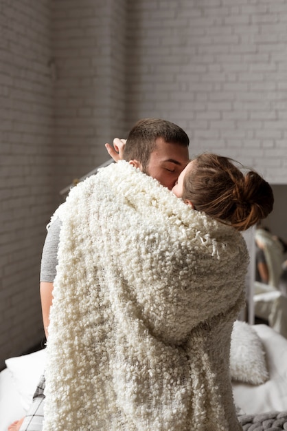 Free photo portrait of young couple kissing